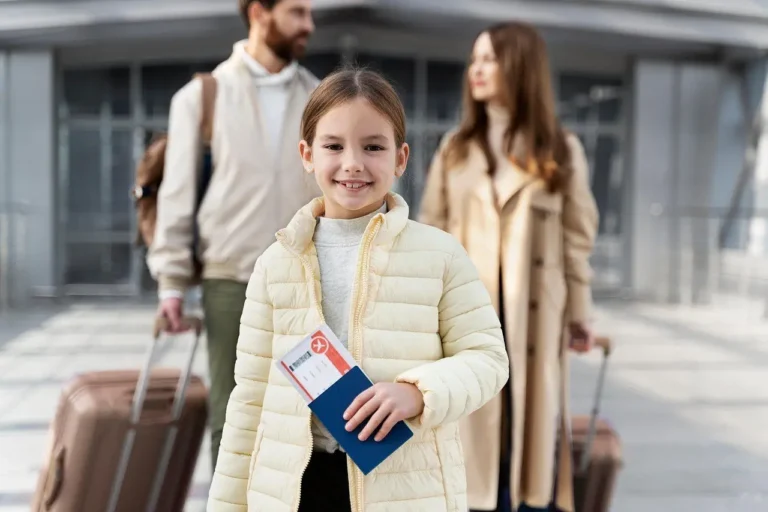 Girl holding a passport and ticket as her parents follow with suitcases