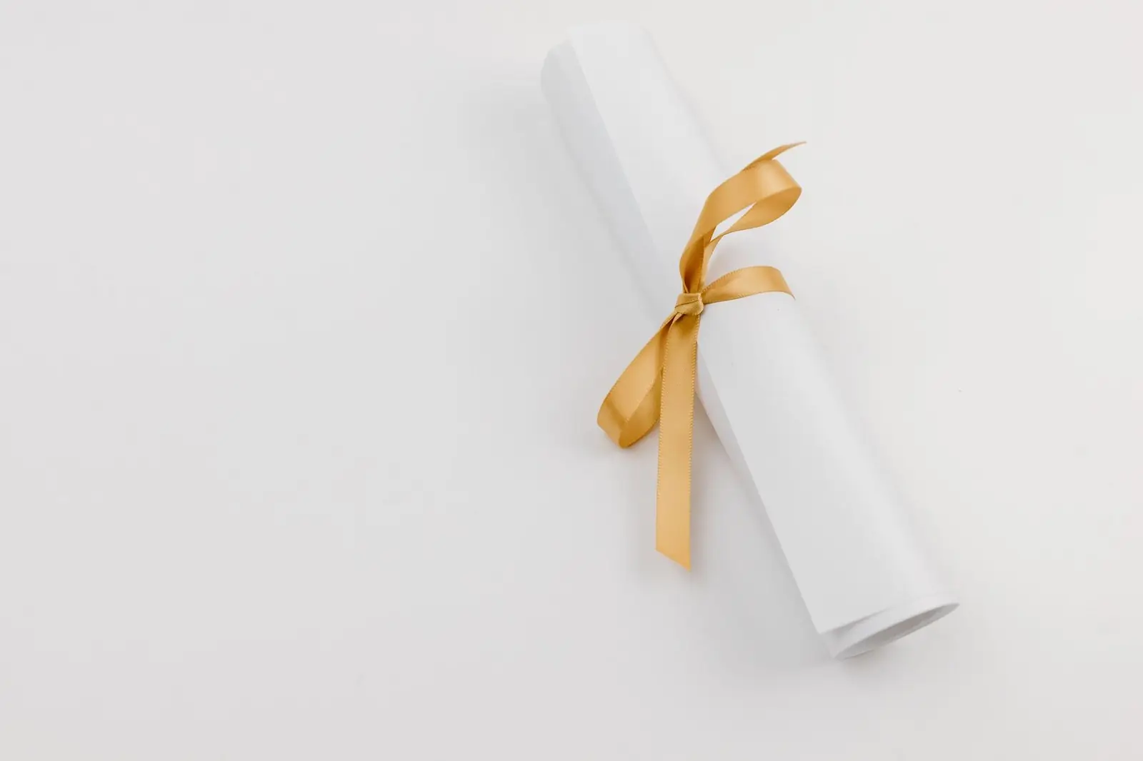 Rolled certificate tied with a gold ribbon