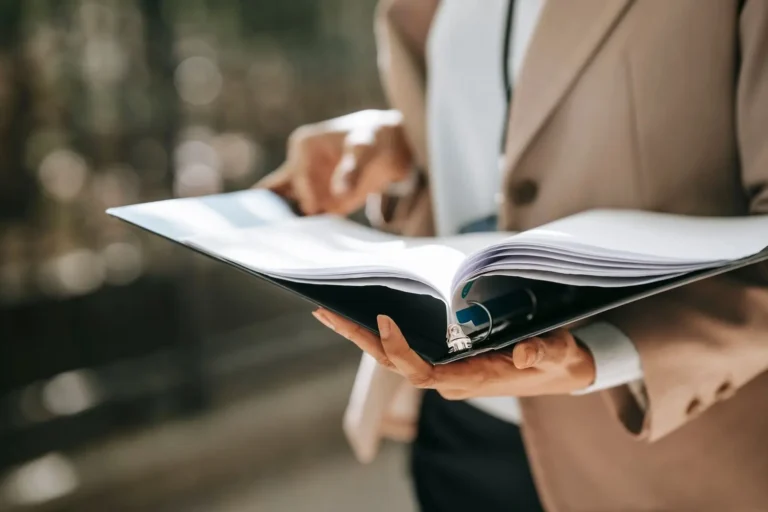 Person reading through a folder of documents