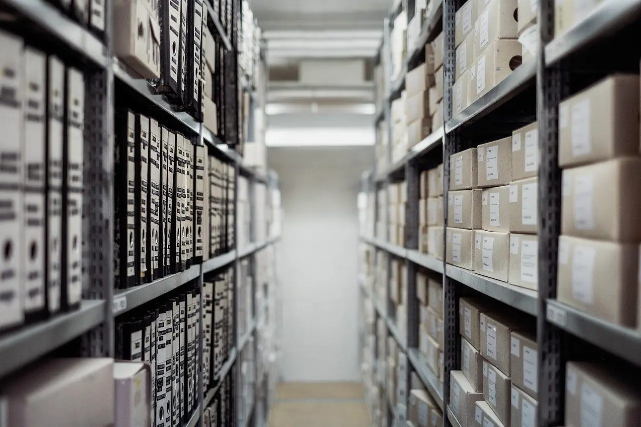 Archive shelves filled with document boxes and binders